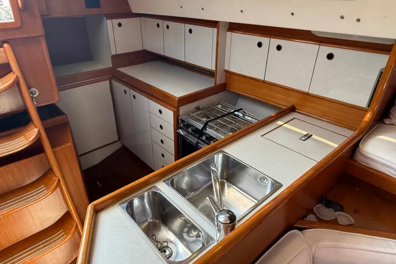Slide: The Image of Interior of 1988 Belliure 41 yacht kitchen with sink, stove, and wooden cabinetry. - 31