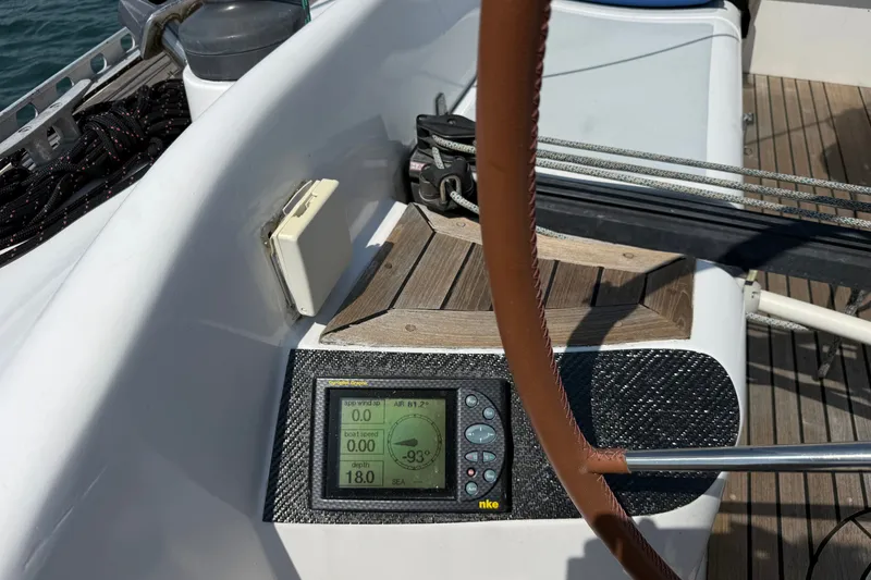 Slide: The Image of Cockpit of 1988 Belliure 41 sailboat with navigation display and leather-wrapped wheel. - 74