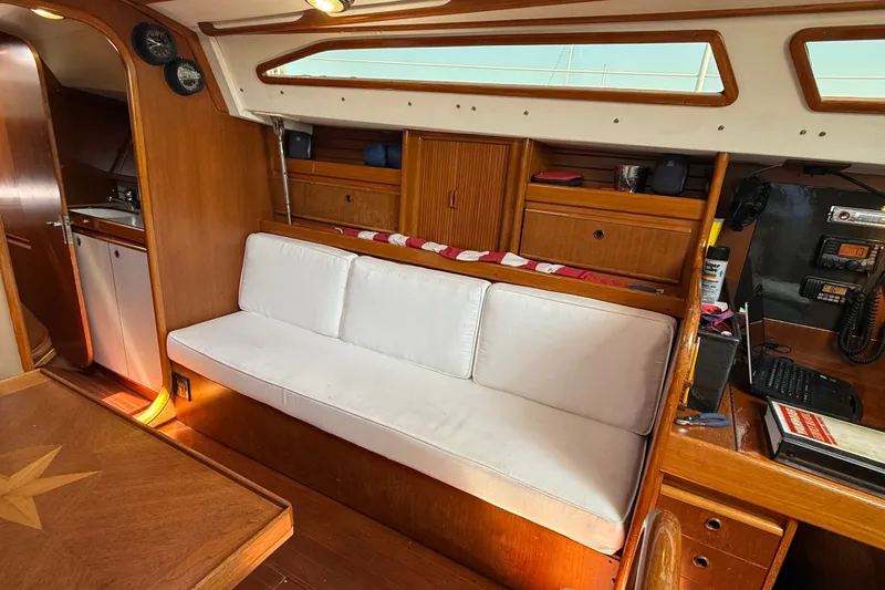 Slide: The Image of Interior of 1988 Belliure 41 yacht with wooden finish and white seating. - 18