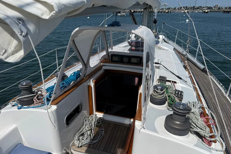 Slide: The Image of 1988 Belliure 41 sailboat deck with ropes and winches, docked in a marina. - 71