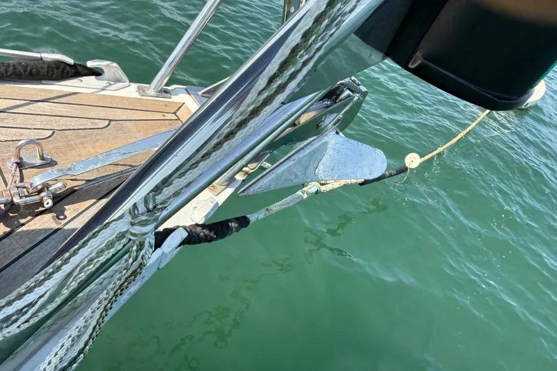 Slide: The Image of Bow of 1988 Belliure 41 yacht with anchor and ropes over green water. - 66
