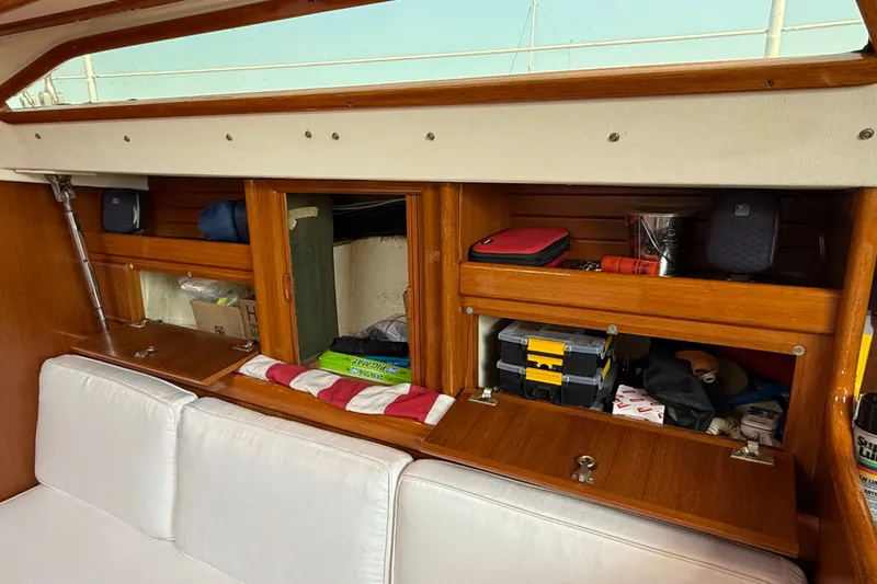 Slide: The Image of Interior of 1988 Belliure 41 yacht with wooden storage compartments and white seating. - 20