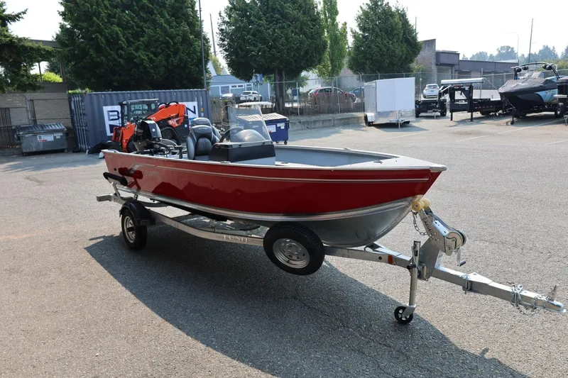 Slide: The Image of A red boat on a trailer, featuring an outboard motor and seating. - 27