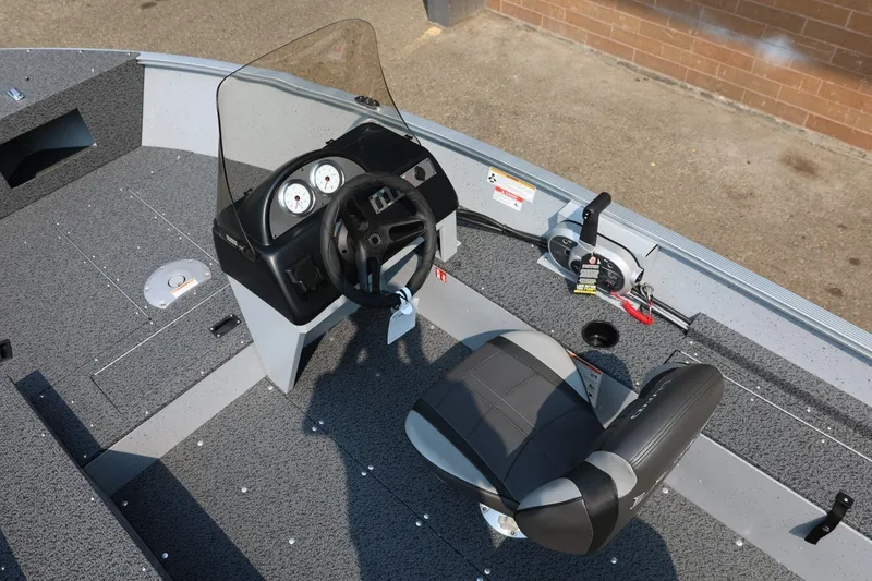 Slide: The Image of The image shows the cockpit of a Lund 1600 Fury SS boat with a helm and seat. - 14