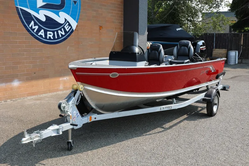 Slide: The Image of Lund 1600 Fury SS 2027: Red aluminum boat on a trailer, featuring a black interior and steering console. - 31