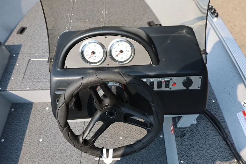 Slide: The Image of The image shows the cockpit of a Lund 1600 Fury SS boat with a steering wheel and gauges. - 15