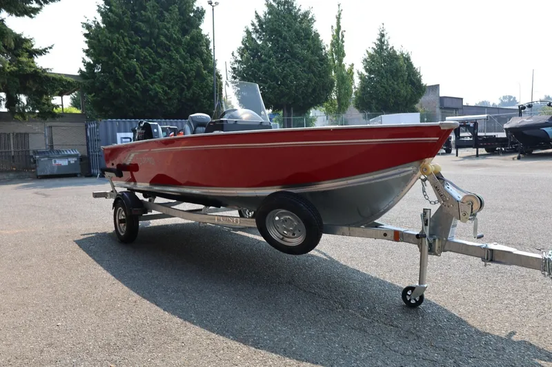 Slide: The Image of A red boat on a trailer, surrounded by trees and buildings. - 28