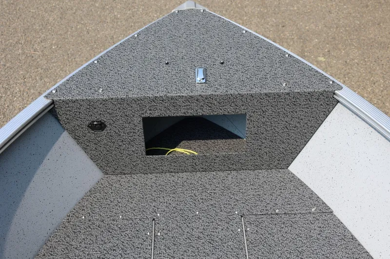Slide: The Image of The image shows the bow of a 2027 Lund 1600 Fury SS boat with gray carpeting. - 8