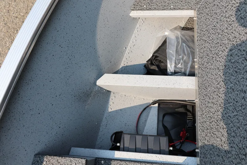 Slide: The Image of Interior view of a Lund 1600 Fury SS boat with gray carpeting and storage space. - 10