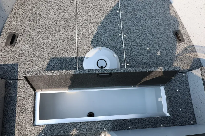 Slide: The Image of The image shows the storage compartment of a 2027 Lund 1600 Fury SS boat. - 12