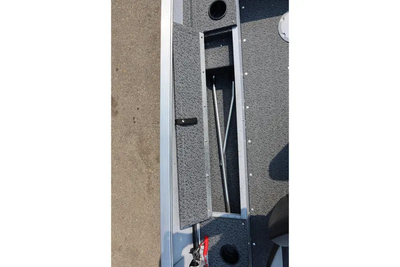 Slide: The Image of Lund 1600 Fury SS 2027: Close-up of gray deck with storage compartment and mounts. - 19