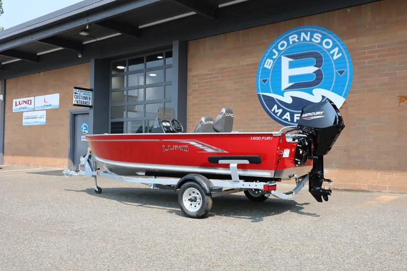 Slide: The Image of 2027 Lund 1600 Fury SS in front of a building with Bjornson Marine logo. - 4