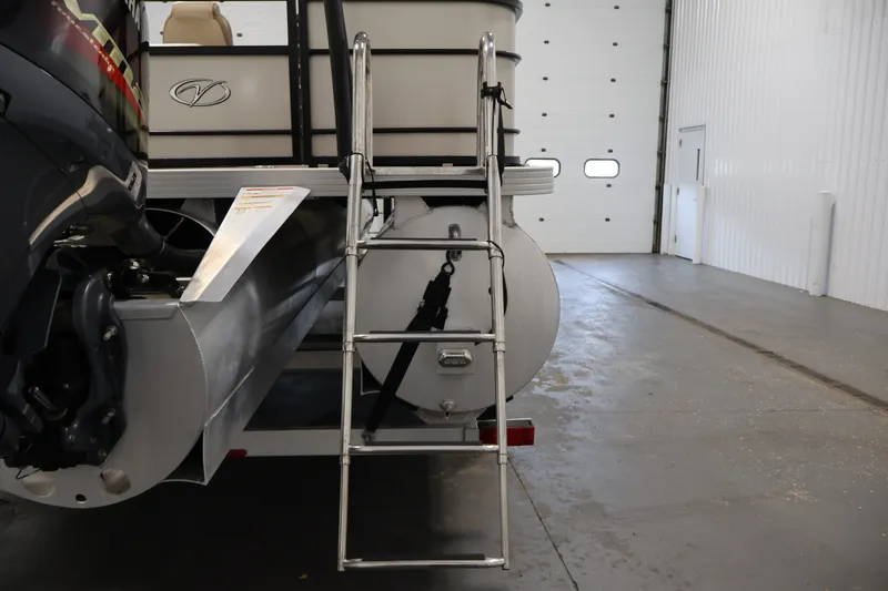Slide: The Image of 2022 Veranda VR22RC pontoon boat rear view with ladder in a garage setting. - 40