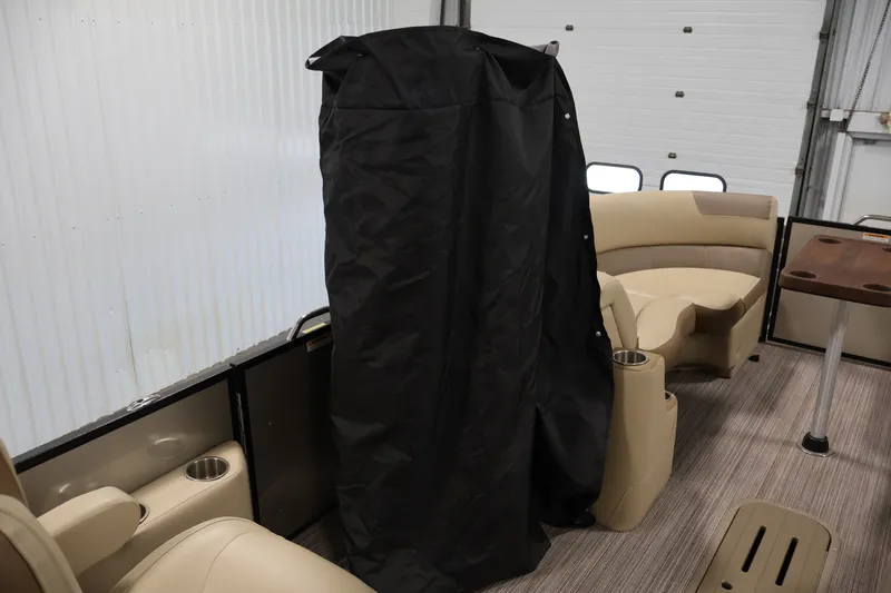 Slide: The Image of 2022 Veranda VR22RC pontoon boat interior with beige seating and black cover. - 18