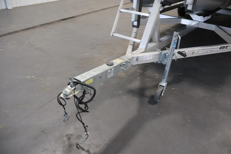 Slide: The Image of Trailer hitch and jack stand of a 2022 Veranda VR22RC boat trailer in a garage. - 45