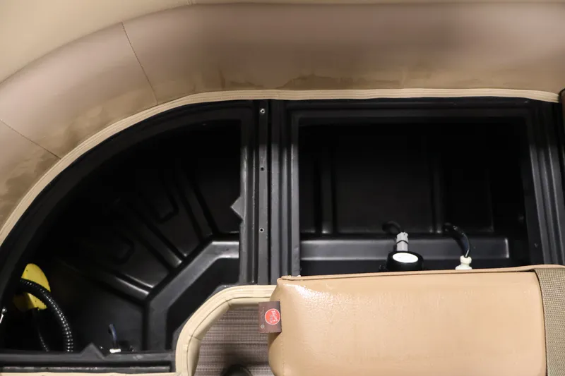Slide: The Image of Interior storage compartment of 2022 Veranda VR22RC boat, featuring beige upholstery and black compartments. - 15