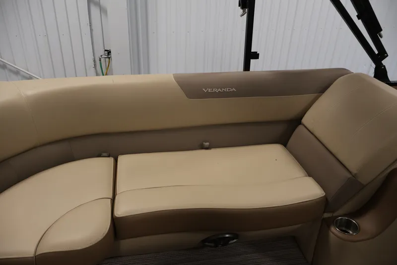 Slide: The Image of 2022 Veranda VR22RC boat interior with beige seating and cup holder. - 35