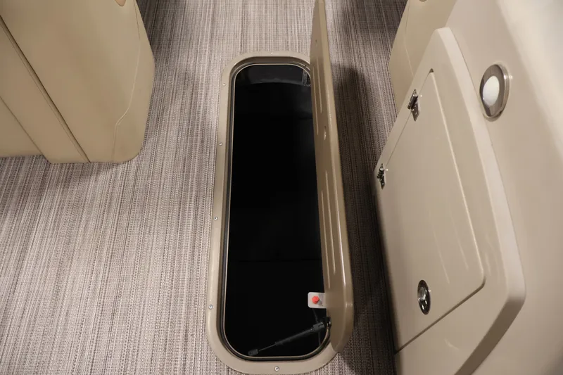 Slide: The Image of Open storage compartment on 2022 Veranda VR22RC boat with beige interior. - 33
