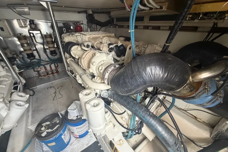 Slide: The Image of Engine room of a 2001 Ocean Yachts 56 Super Sport, showcasing mechanical components. - 13