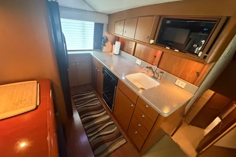 Slide: The Image of Luxurious kitchen interior of 2001 Ocean Yachts 56 Super Sport with modern amenities. - 25