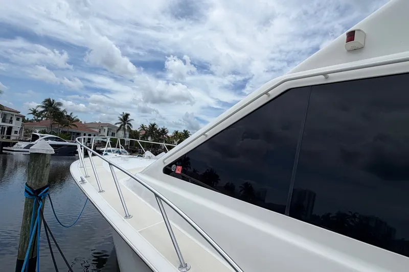 Slide: The Image of 2001 Ocean Yachts 56 Super Sport docked, showcasing sleek design and waterfront view. - 7