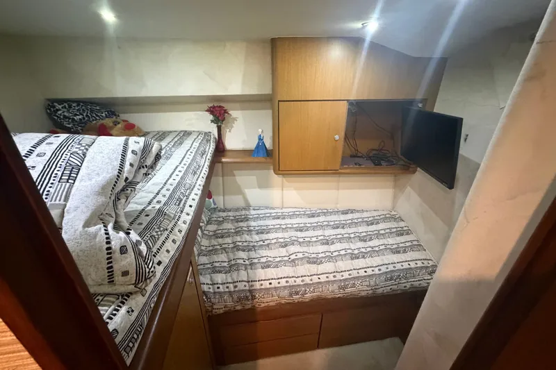 Slide: The Image of Cozy cabin interior of 2001 Ocean Yachts 56 Super Sport with twin beds and TV. - 35