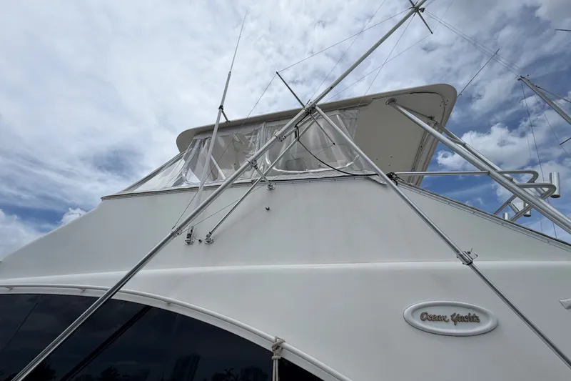 Slide: The Image of 2001 Ocean Yachts 56 Super Sport boat under cloudy sky, showcasing sleek design. - 6