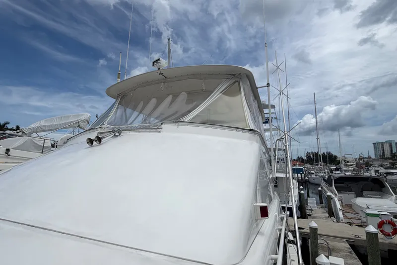 Slide: The Image of 2001 Ocean Yachts 56 Super Sport docked at marina under cloudy sky. - 11