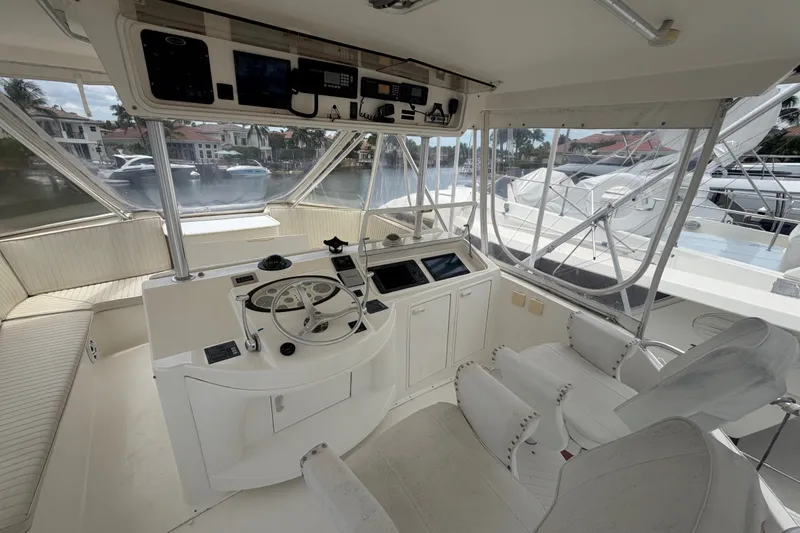 Slide: The Image of Cockpit of 2001 Ocean Yachts 56 Super Sport with helm and seating, docked at marina. - 41