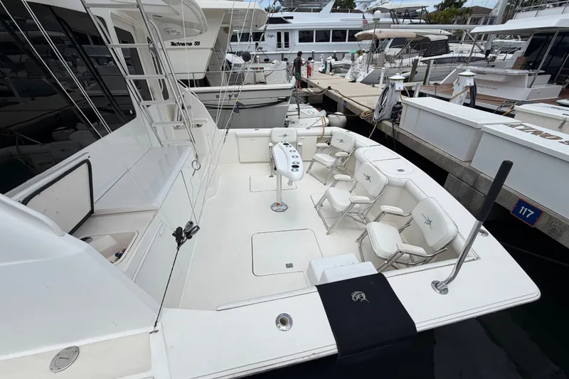 Slide: The Image of 2001 Ocean Yachts 56 Super Sport docked, featuring spacious deck with seating and fishing equipment. - 3