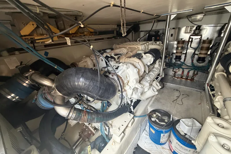 Slide: The Image of Engine room of a 2001 Ocean Yachts 56 Super Sport, showcasing machinery and components. - 14