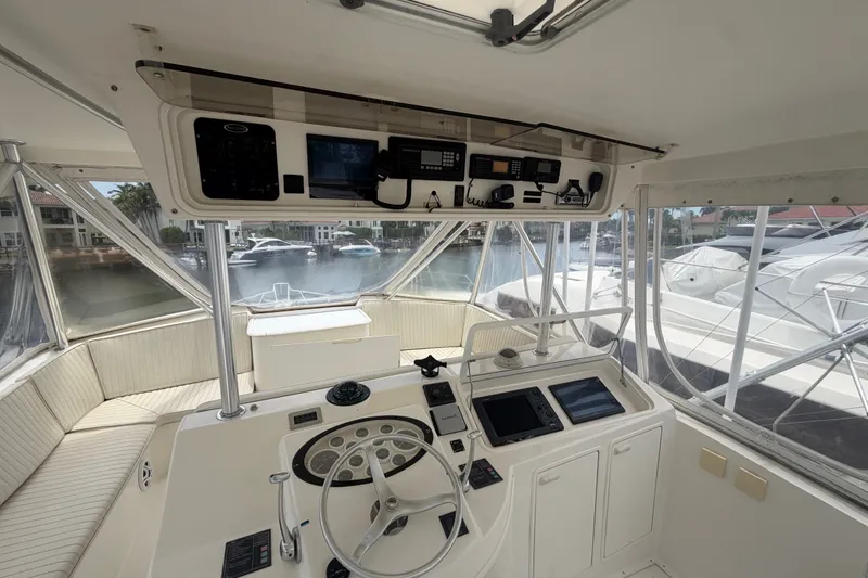 Slide: The Image of Cockpit of 2001 Ocean Yachts 56 Super Sport with navigation equipment and marina view. - 42