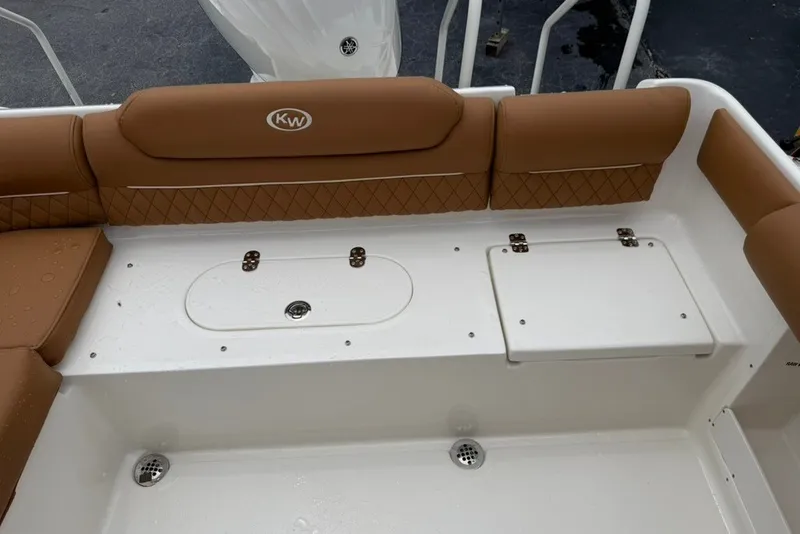 Slide: The Image of 2027 Key West 239 DFS boat interior with tan seating and storage compartments. - 17