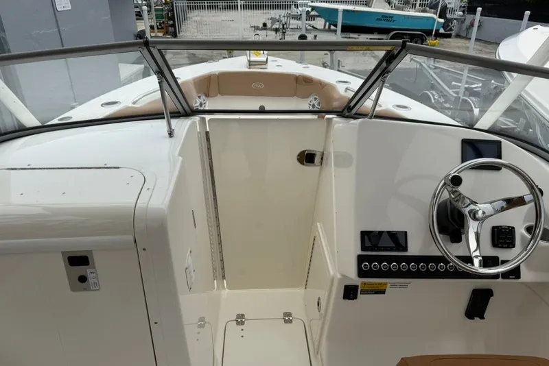 Slide: The Image of 2027 Key West 239 DFS boat cockpit with steering wheel and control panel. - 11