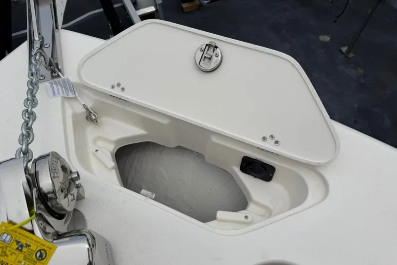 Slide: The Image of Open anchor locker on 2027 Key West 239 DFS boat, showcasing storage and chain mechanism. - 46