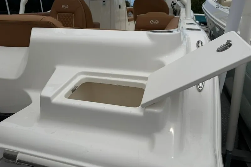 Slide: The Image of 2027 Key West 239 DFS boat with open storage compartment and brown seating. - 51
