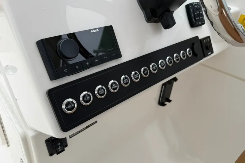 Slide: The Image of Control panel of 2027 Key West 239 DFS boat with buttons and stereo system. - 29