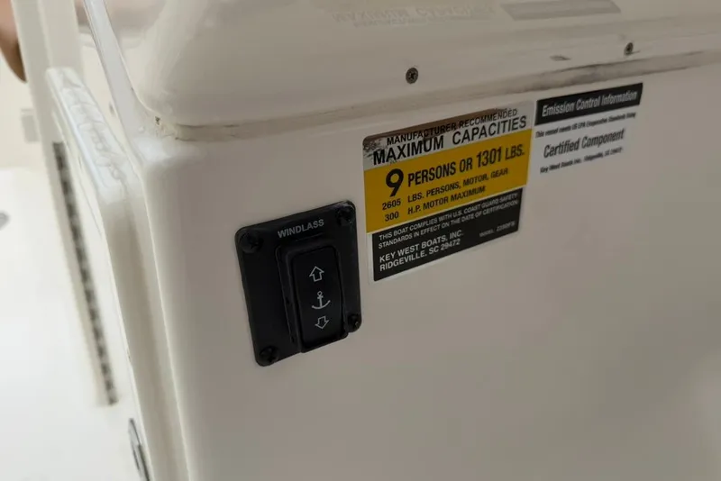 Slide: The Image of 2027 Key West 239 DFS boat capacity label and windlass control panel. - 33