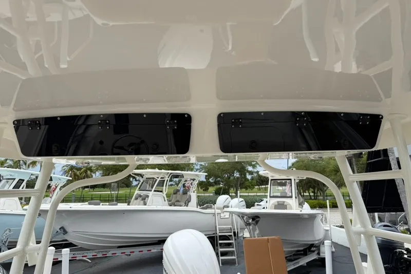 Slide: The Image of 2027 Key West 239 DFS boat interior with storage compartments and visible exterior boats. - 34