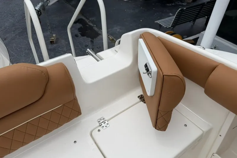 Slide: The Image of 2027 Key West 239 DFS boat interior with tan cushioned seating and white accents. - 22