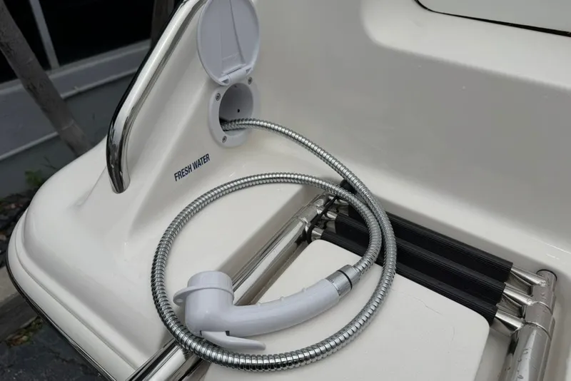 Slide: The Image of Freshwater hose on 2027 Key West 239 DFS boat deck, coiled and ready for use. - 47