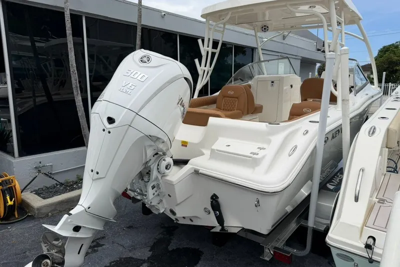 Slide: The Image of 2027 Key West 239 DFS boat with Yamaha 300 V6 engine, docked outdoors. - 4