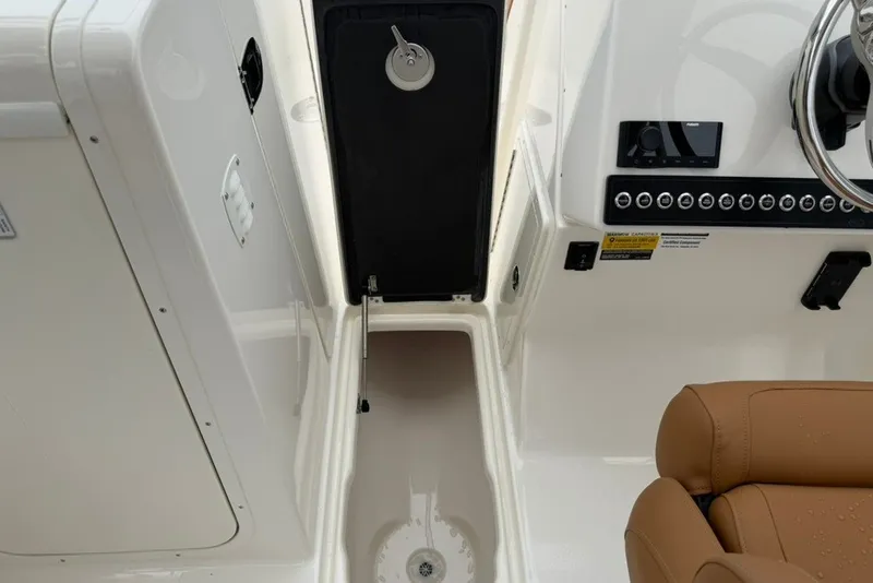 Slide: The Image of 2027 Key West 239 DFS boat interior with storage compartment and control panel. - 37