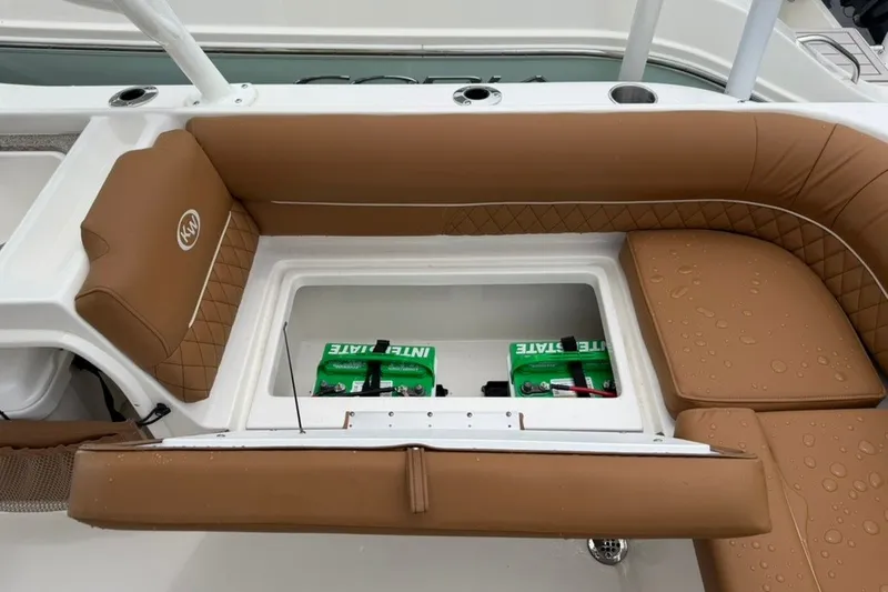 Slide: The Image of Key West 239 DFS 2027 boat interior with brown seating and storage compartment. - 16