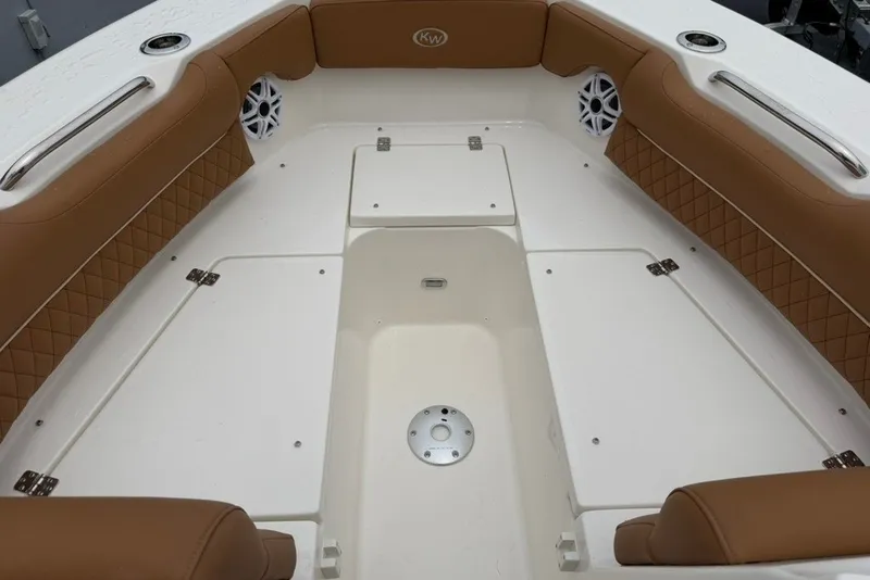 Slide: The Image of Interior of 2027 Key West 239 DFS boat with tan seating and storage compartments. - 27