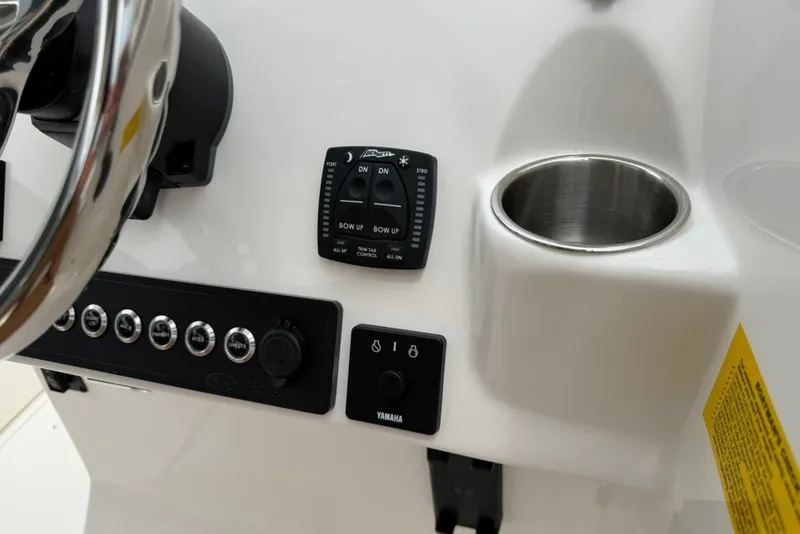 Slide: The Image of Dashboard of 2027 Key West 239 DFS boat with controls and cup holder. - 30