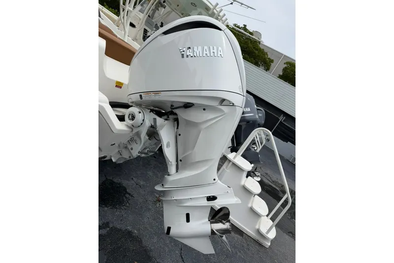 Slide: The Image of 2027 Key West 239 DFS boat with Yamaha outboard motor, docked on pavement. - 6