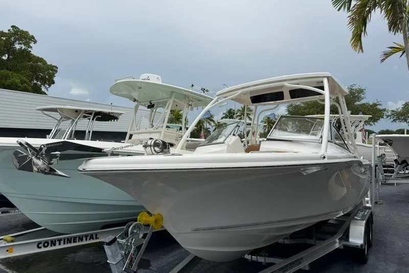 Slide: The Image of 2027 Key West 239 DFS boat on trailer, displayed outdoors with other boats. - 2