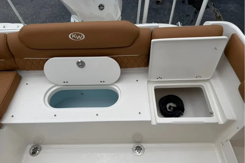 Slide: The Image of 2027 Key West 239 DFS boat interior with storage compartments and cushioned seating. - 18