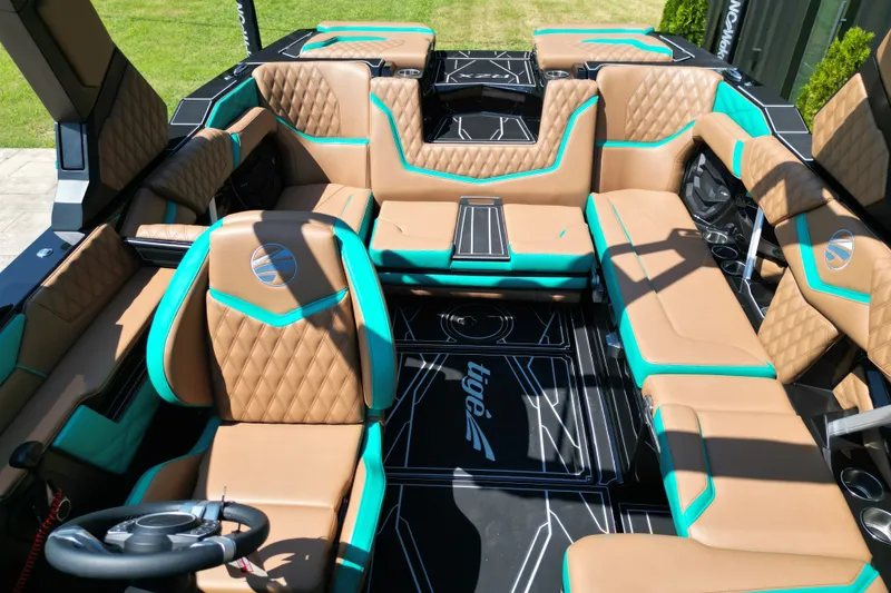 Slide: The Image of Luxurious interior of 2027 Tigé 22RZX boat with tan and teal seating. - 8
